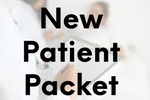 A new patient packet is being written on.