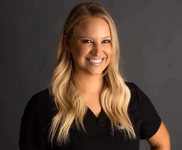 A woman with blonde hair wearing black shirt.