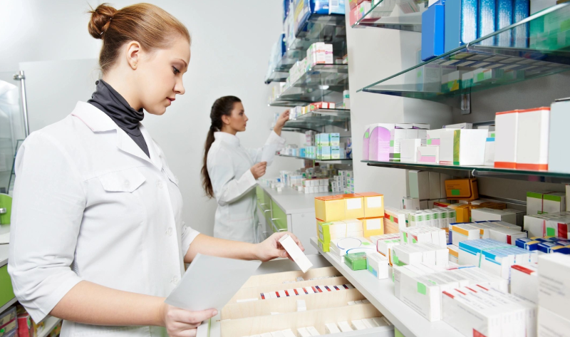 Two women are working in a pharmacy.