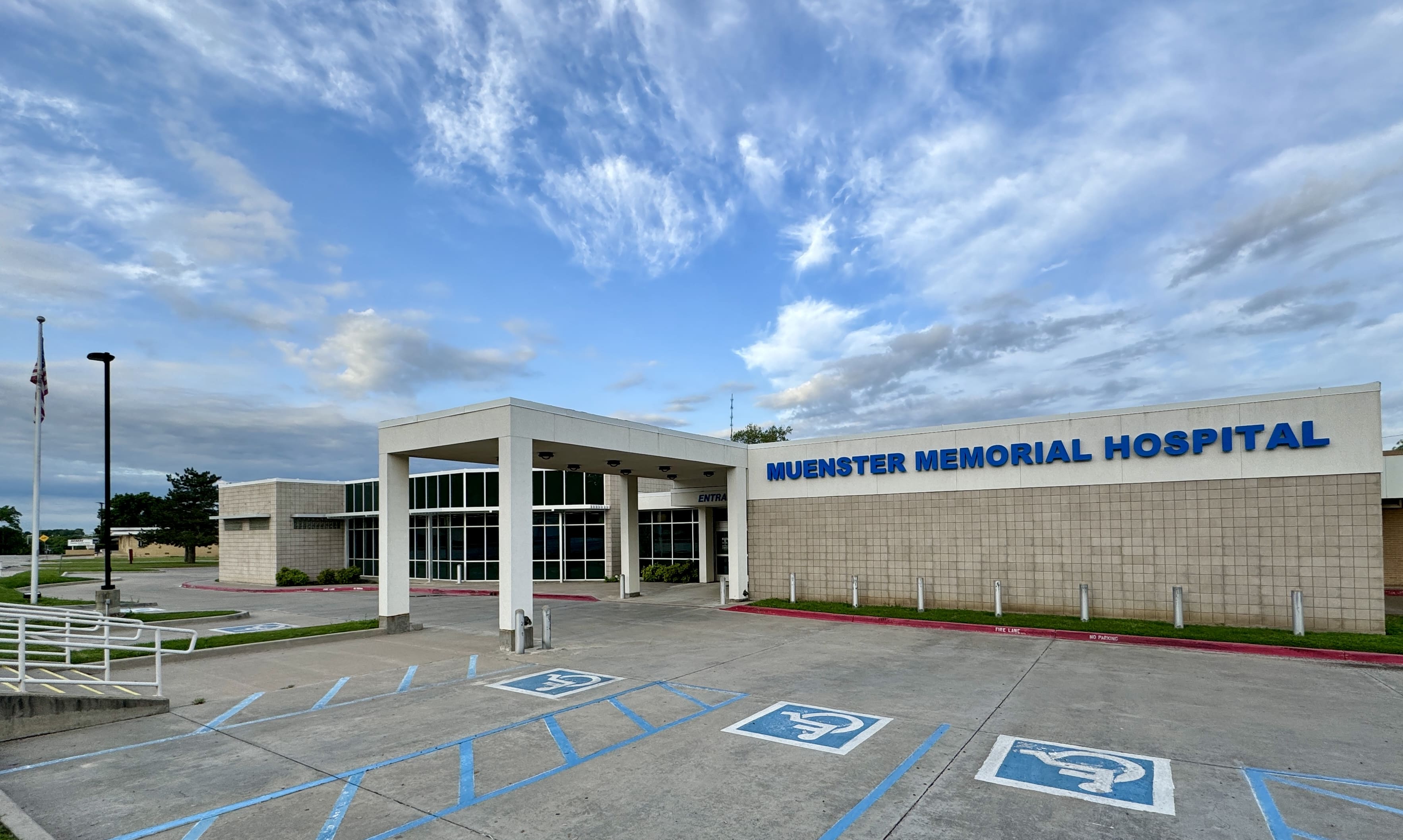 A large building with a parking lot in front of it.