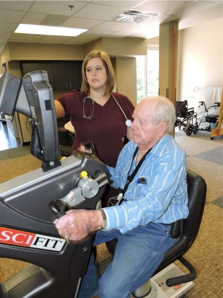 Older man using a SciFit exercise machine.