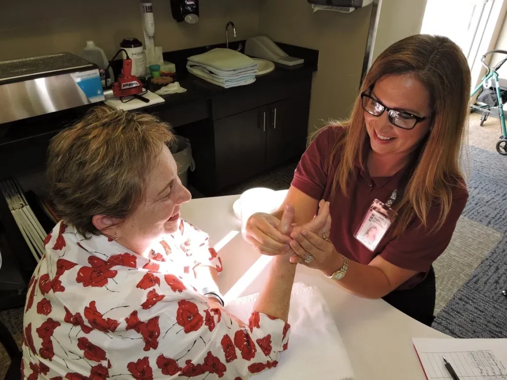 Woman receiving hand therapy from therapist.