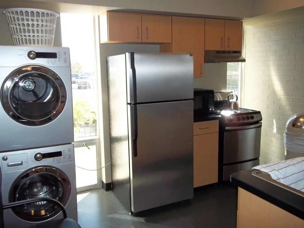 Stainless steel kitchen appliances in a room.