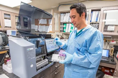 Lab technician working with lab equipment.